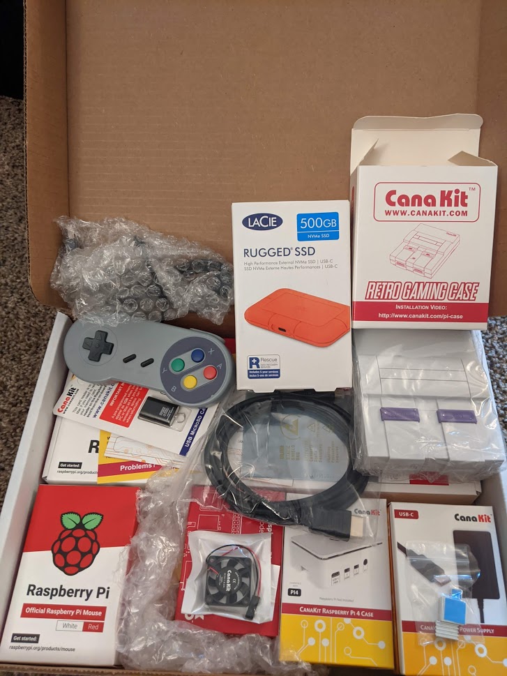 A box full of gear containing the Raspberry Pi 4 Computer, Case, Controllers and External SSD