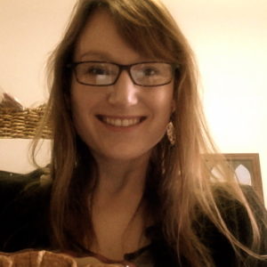 Headshot of Kristen Mapes with glasses and smiling 