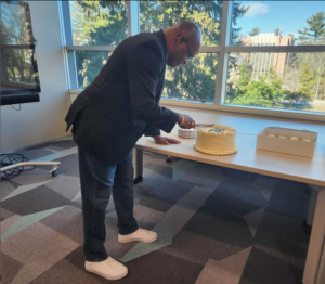 African Studies Librarian Erik Ponder cuts the Douglass Day cake.